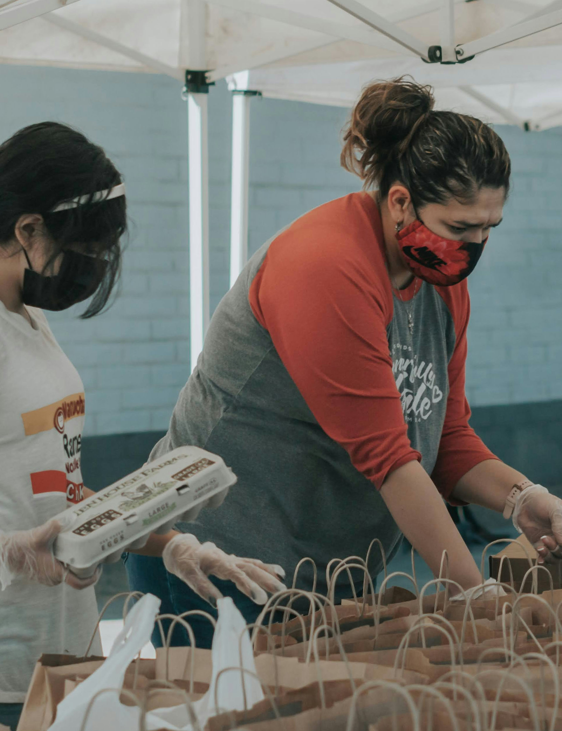 Volunteers putting groceries in bags
